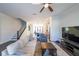 Bright living room featuring hardwood floors, staircase, and views into the kitchen at 419 Hargrove Ln, Decatur, GA 30030