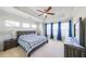 Main bedroom featuring a tray ceiling, ceiling fan, and a large window at 419 Hargrove Ln, Decatur, GA 30030