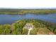 Picturesque aerial shot of a beautiful home surrounded by green trees, near a serene lake at 840 Old Driver Road, Whitesburg, GA 30185