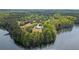Panoramic aerial view of a lake house surrounded by dense forests and a tranquil lake at 840 Old Driver Road, Whitesburg, GA 30185