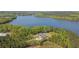 Scenic aerial view showcases a lakeside house with a private driveway surrounded by flourishing trees at 840 Old Driver Road, Whitesburg, GA 30185