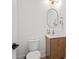 Half-bathroom features toilet, vanity with granite counters, modern fixtures, and wood cabinets at 840 Old Driver Road, Whitesburg, GA 30185