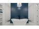 Luxurious bathroom with freestanding tub, blue accent wall, and access to a tiled shower at 840 Old Driver Road, Whitesburg, GA 30185