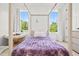 Cozy bedroom with hardwood frame bed, papasan chair, and natural light streaming in from the windows at 840 Old Driver Road, Whitesburg, GA 30185