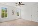 Bright bedroom features hardwood floors, modern ceiling fan, and plenty of natural light from two large windows at 840 Old Driver Road, Whitesburg, GA 30185