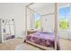 Bedroom features hardwood frame bed, decor mirror and papasan chair, plus plenty of natural light from the windows at 840 Old Driver Road, Whitesburg, GA 30185