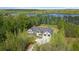 Stunning lake house with mature trees, a modern farmhouse style, and beautiful garage doors at 840 Old Driver Road, Whitesburg, GA 30185