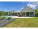 Spacious backyard with a pool, patio, and lush greenery, perfect for outdoor activities and relaxation at 840 Old Driver Road, Whitesburg, GA 30185