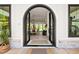 Grand arched double door entry way and foyer with hardwood floors and a view of the dining room at 840 Old Driver Road, Whitesburg, GA 30185
