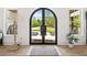 Lovely arched, iron double door entry way with hardwood floors and view of mature trees at 840 Old Driver Road, Whitesburg, GA 30185