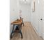 Hallway with hardwood floors and wooden accent table adds warmth and character to the entrance at 840 Old Driver Road, Whitesburg, GA 30185