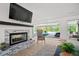 Living space featuring a fireplace and views of the outdoor patio, putting green, and swimming pool at 840 Old Driver Road, Whitesburg, GA 30185