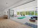 Indoor living space opens to an outdoor patio with a pool and entertainment area through sliding glass doors at 840 Old Driver Road, Whitesburg, GA 30185
