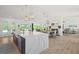 Bright, open-concept kitchen with a large island, marble countertops, and modern pendant lighting at 840 Old Driver Road, Whitesburg, GA 30185