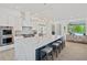 Modern kitchen with waterfall countertops on a large island and high-end stainless steel appliances at 840 Old Driver Road, Whitesburg, GA 30185