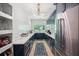 A modern butler's pantry features navy cabinets, white countertops, and stylish fixtures, a sleek design at 840 Old Driver Road, Whitesburg, GA 30185