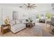 Bright living room with a comfortable sectional sofa and large windows overlooking the backyard at 840 Old Driver Road, Whitesburg, GA 30185