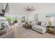 Comfortable living room featuring a ceiling fan, large sectional sofa, and outdoor views at 840 Old Driver Road, Whitesburg, GA 30185