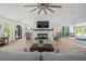 Open living room with a fireplace, neutral colors, and access to the outdoor entertainment space at 840 Old Driver Road, Whitesburg, GA 30185