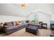 Attic living room with large sectional couch and natural light at 840 Old Driver Road, Whitesburg, GA 30185