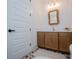 Cozy powder room featuring a vanity with decorative floor tiles and a stylish mirror for a welcoming touch at 840 Old Driver Road, Whitesburg, GA 30185