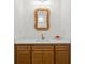 Stylish powder room with a modern mirror and a sleek vanity, blending functionality with elegant design at 840 Old Driver Road, Whitesburg, GA 30185