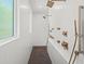 Bright shower boasts several shower heads and bronze fixtures, complemented by white tile at 840 Old Driver Road, Whitesburg, GA 30185