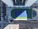 Aerial view of an outdoor tennis and basketball court within a fenced recreational area, surrounded by city buildings at 1280 W Peachtree Nw St # 3714, Atlanta, GA 30309