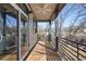 Spacious balcony with wooden floors, metal railings, and a ceiling fan for comfortable outdoor living at 147 Hutchinson Ne St, Atlanta, GA 30307