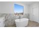 Bright bathroom showcases a freestanding tub near a large window offering great views at 147 Hutchinson Ne St, Atlanta, GA 30307