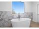 Bright bathroom showcases a freestanding tub near a large window offering great views at 147 Hutchinson Ne St, Atlanta, GA 30307