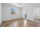 Bright bedroom with hardwood floors, a large window, and access to a balcony for natural light and views at 147 Hutchinson Ne St, Atlanta, GA 30307