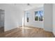 Bright, minimalist bedroom with hardwood floors and large windows at 147 Hutchinson Ne St, Atlanta, GA 30307
