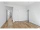 Bright, minimalist bedroom with hardwood floors and white door frames at 147 Hutchinson Ne St, Atlanta, GA 30307
