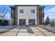 Modern home with a two-car garage, stone accents, and a well-designed driveway at 147 Hutchinson Ne St, Atlanta, GA 30307