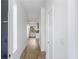 Bright hallway with hardwood floors and white walls leading towards the kitchen and dining area at 147 Hutchinson Ne St, Atlanta, GA 30307