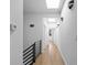 Bright hallway with hardwood floors, recessed lighting, and skylights for a modern, airy feel at 147 Hutchinson Ne St, Atlanta, GA 30307