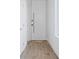 Hallway featuring a white door, hardwood floors and white walls at 147 Hutchinson Ne St, Atlanta, GA 30307