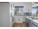 Well-equipped kitchen featuring stainless steel appliances, white cabinets and a blue subway tile backsplash at 147 Hutchinson Ne St, Atlanta, GA 30307