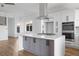 Open-concept kitchen with gray island, stainless steel appliances, and view into the living area at 147 Hutchinson Ne St, Atlanta, GA 30307
