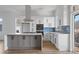 Stylish kitchen featuring white and gray cabinetry, stainless steel appliances, and bright blue backsplash at 147 Hutchinson Ne St, Atlanta, GA 30307