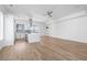 Open-concept living room with modern kitchen, hardwood floors, and bright white walls at 147 Hutchinson Ne St, Atlanta, GA 30307