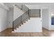 Living room with a wooden staircase and railing at 147 Hutchinson Ne St, Atlanta, GA 30307
