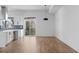 Open living room with modern kitchen, hardwood floors, and a sliding glass door to a balcony at 147 Hutchinson Ne St, Atlanta, GA 30307