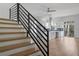 Modern staircase with black metal railings, leading to a stylish open concept living and kitchen area at 147 Hutchinson Ne St, Atlanta, GA 30307