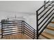Stylish staircase featuring wood treads, black railings, and an open layout for a modern feel at 147 Hutchinson Ne St, Atlanta, GA 30307
