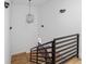 Elegant staircase with a modern chandelier, black railings, and wood treads for a sleek design at 147 Hutchinson Ne St, Atlanta, GA 30307