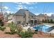 Beautiful backyard featuring a sparkling pool, patio, and outdoor kitchen, perfect for entertaining at 3759 Chapel Cv, Douglasville, GA 30135