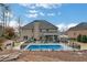 Spacious backyard featuring a private pool, patio area, and meticulous landscaping at 3759 Chapel Cv, Douglasville, GA 30135
