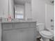 Clean bathroom with white fixtures, gray vanity, and a shower and tub combination at 3759 Chapel Cv, Douglasville, GA 30135